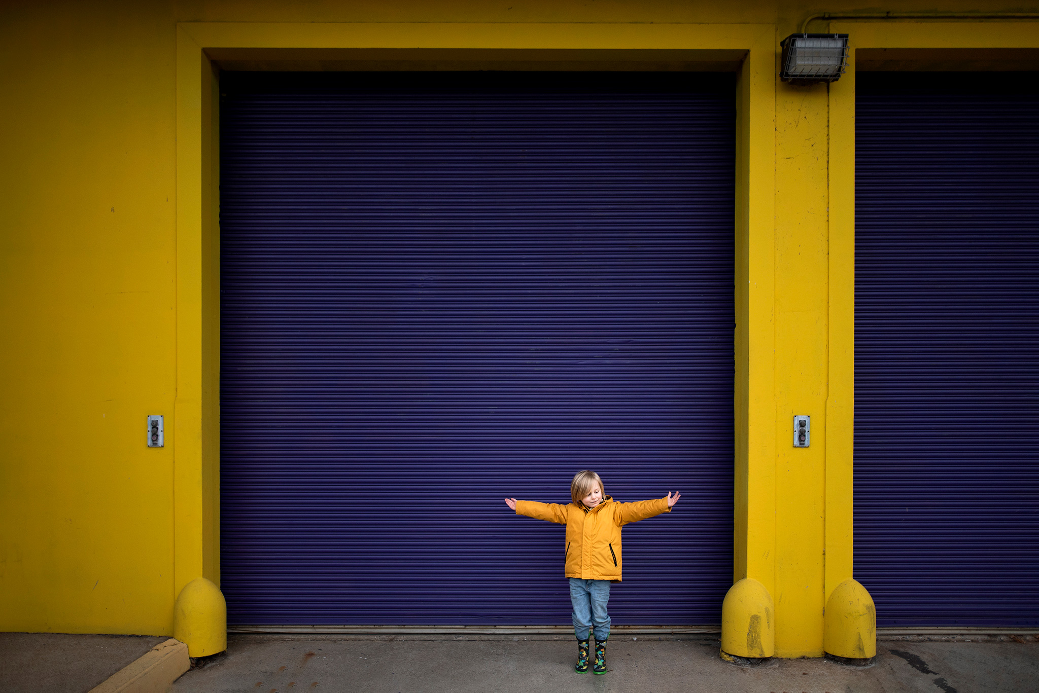 Color Theory boy in yellow jacket in front for purple door