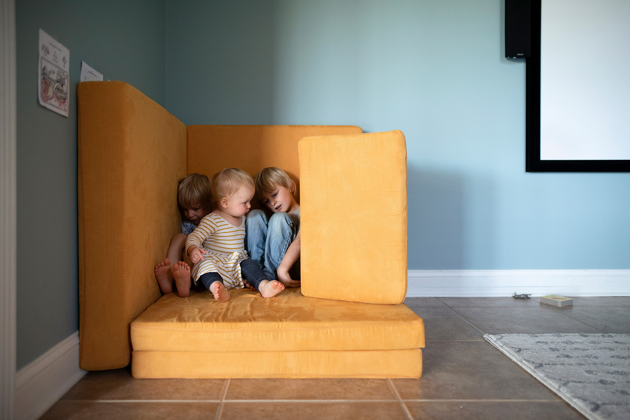 Color Theory children on yellow cushions