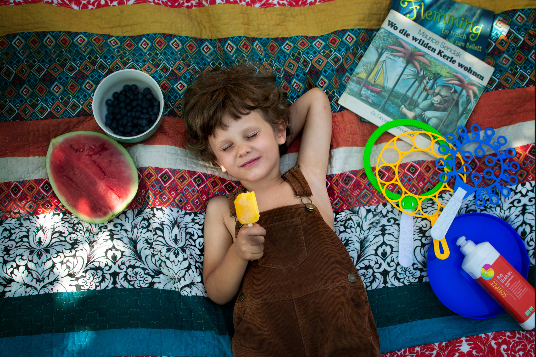 Child laying on picnic blanket