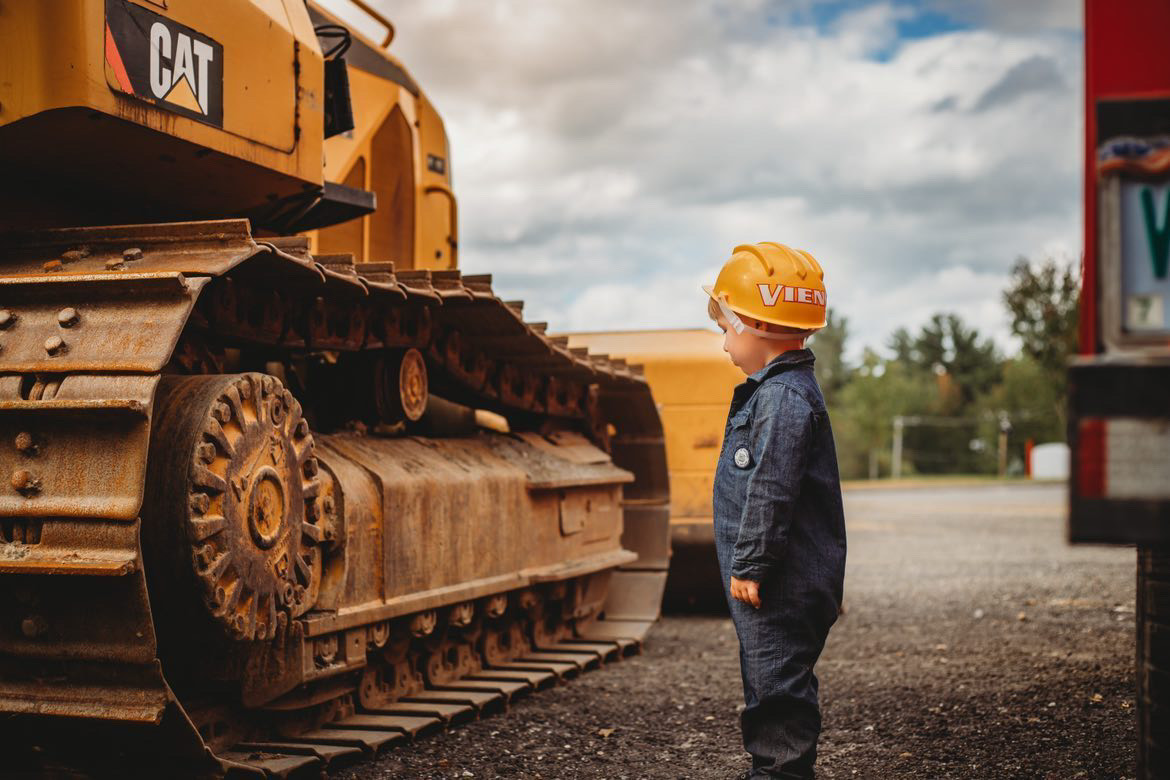 Boy next to bulldozer