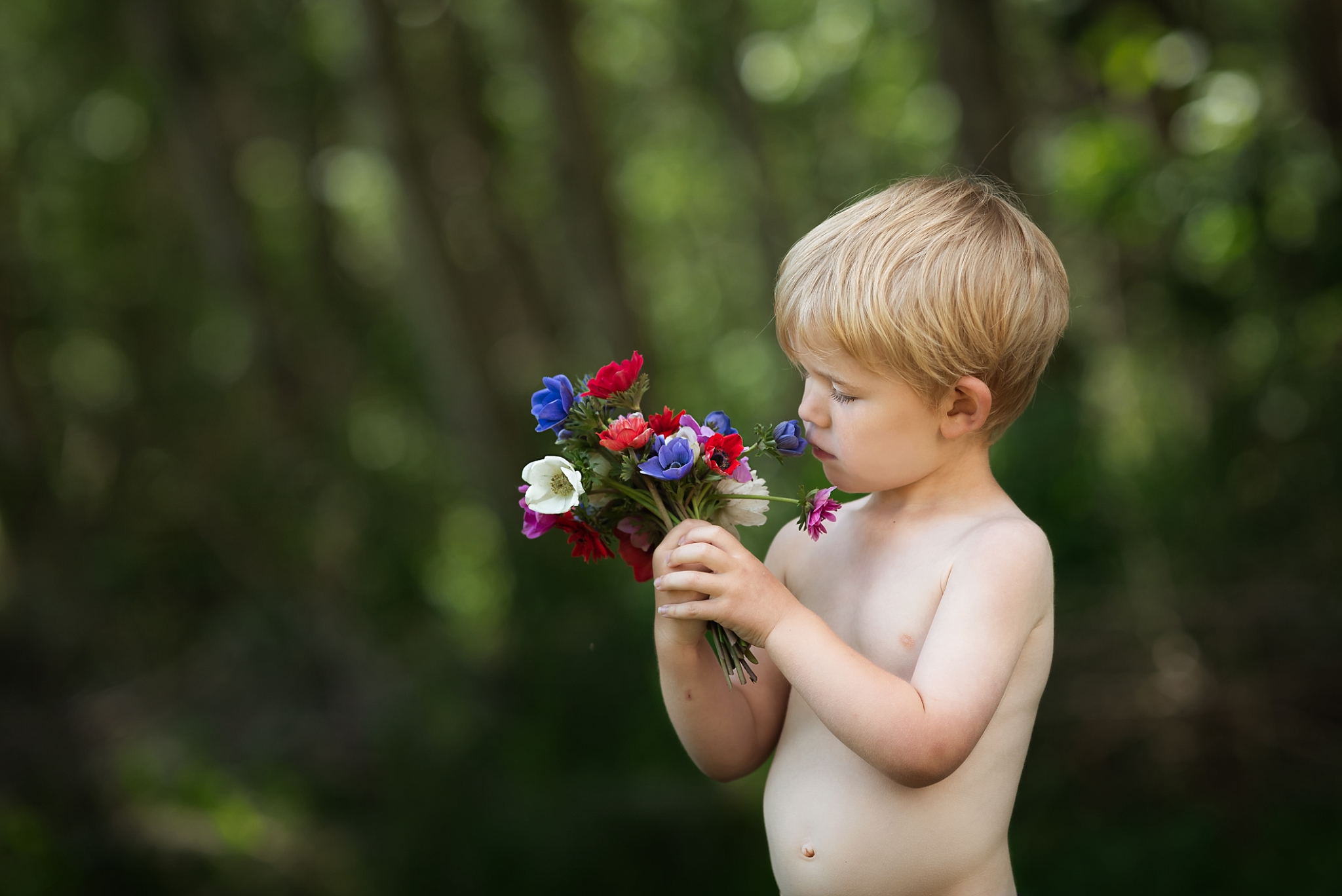Little boy holding flowers