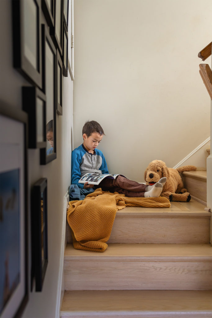 Child reading on the stairs