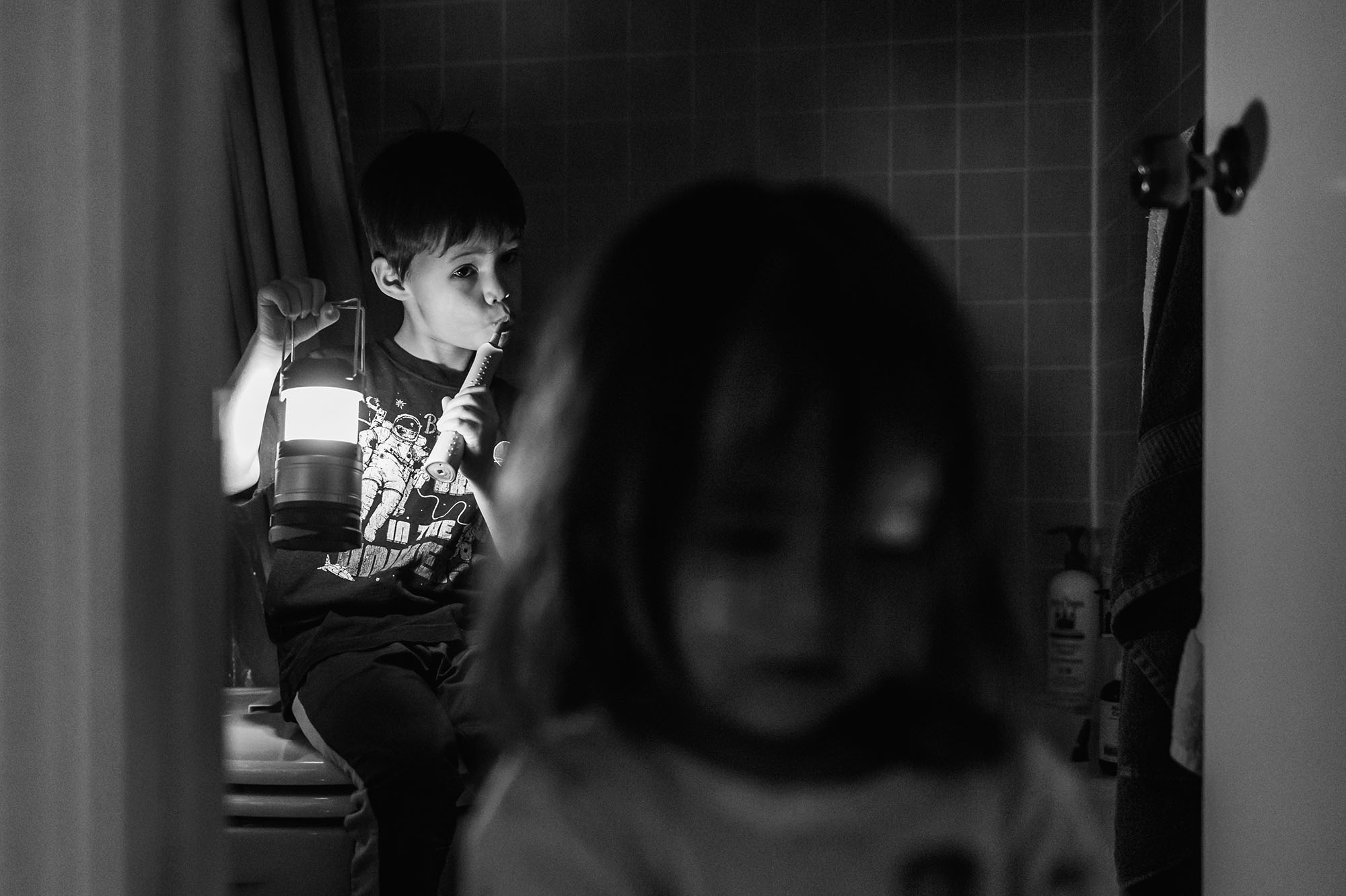 Black and white of children in the bathroom