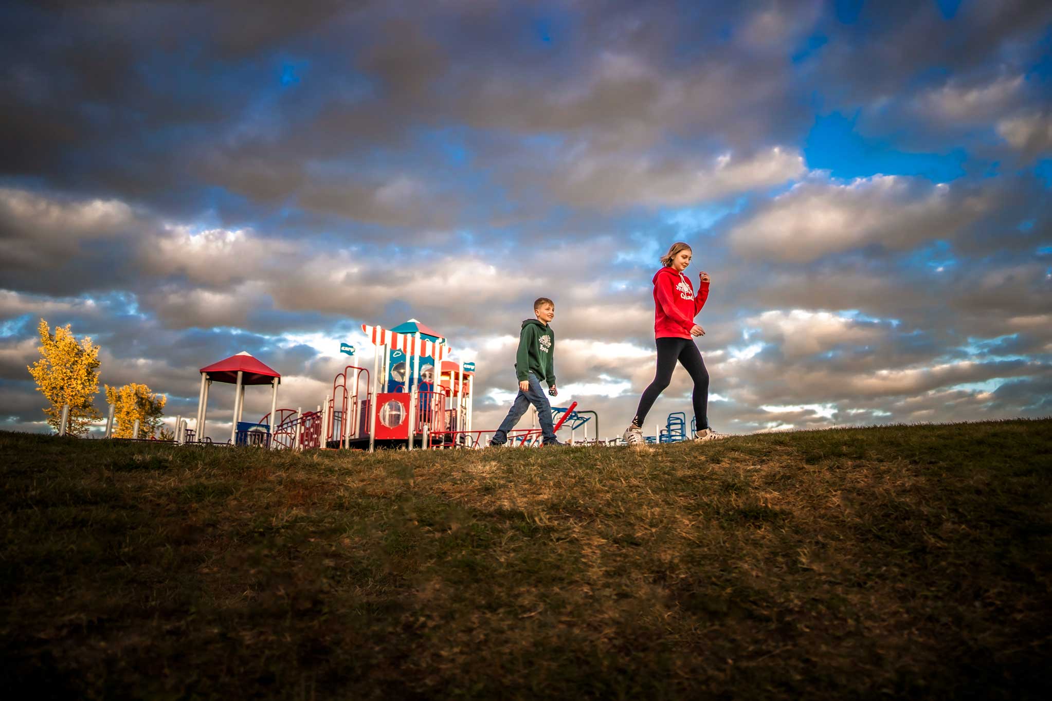 Children at a playground with big sky