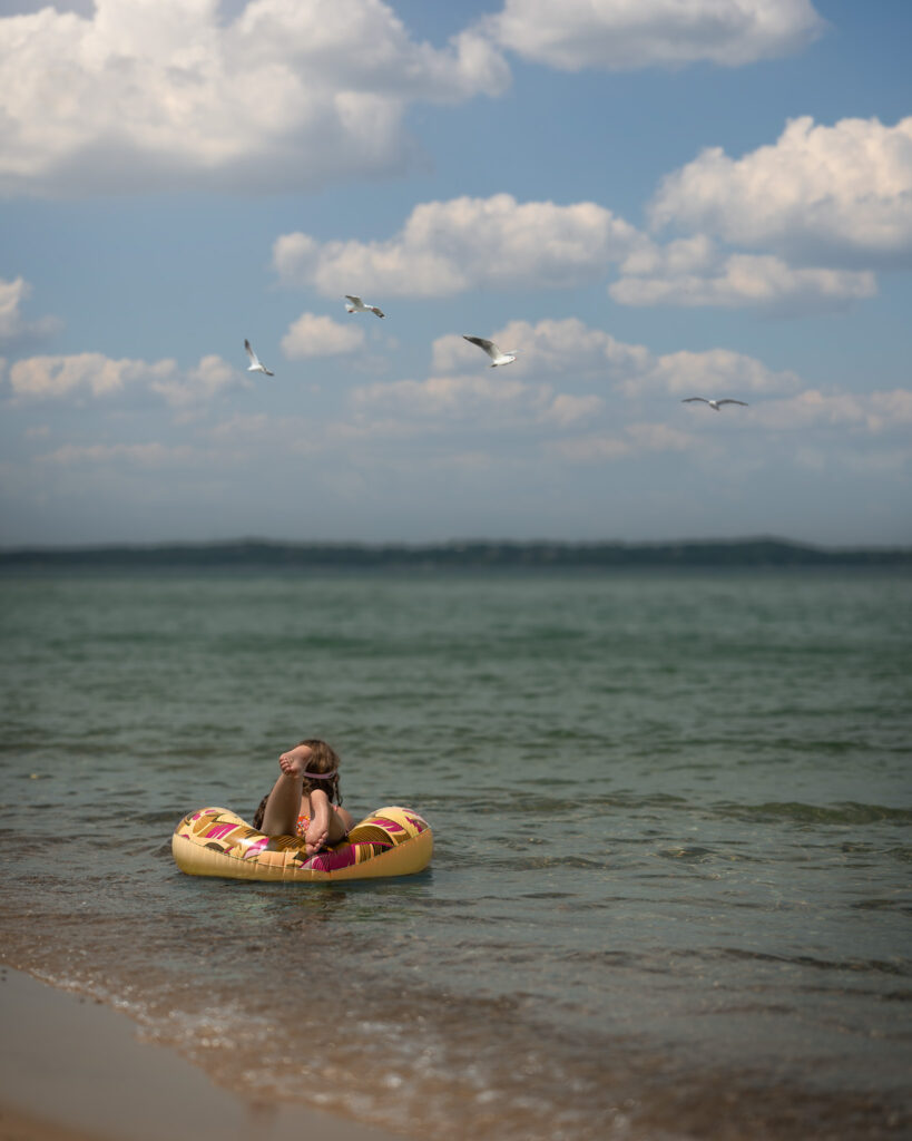 Girl swimming in the lake on floatie