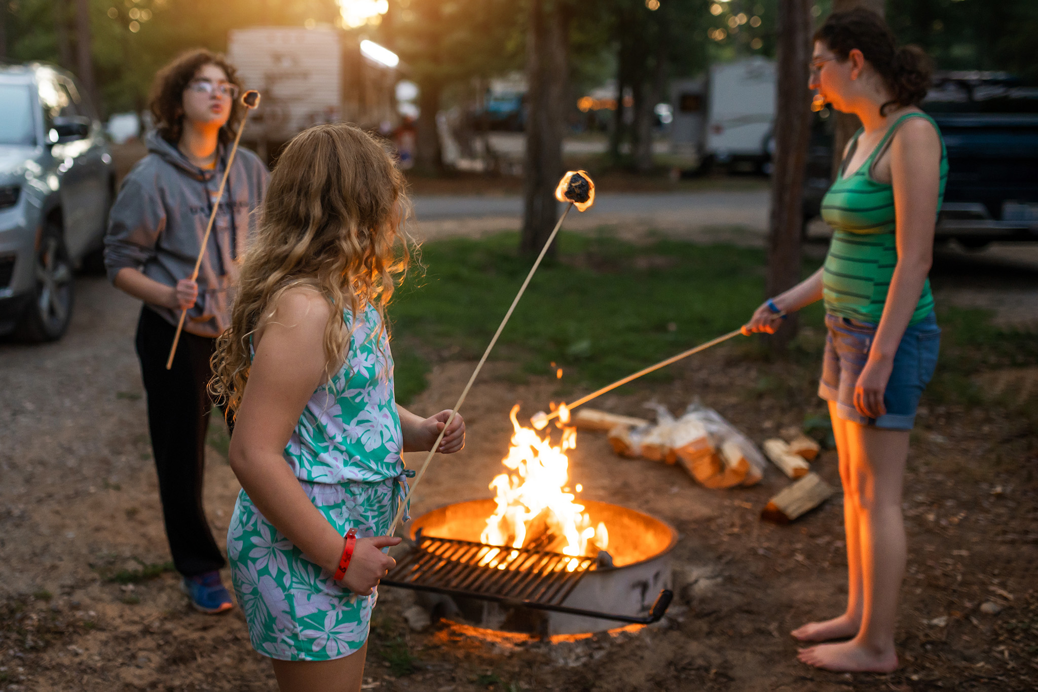 three kids roasting marshmallows