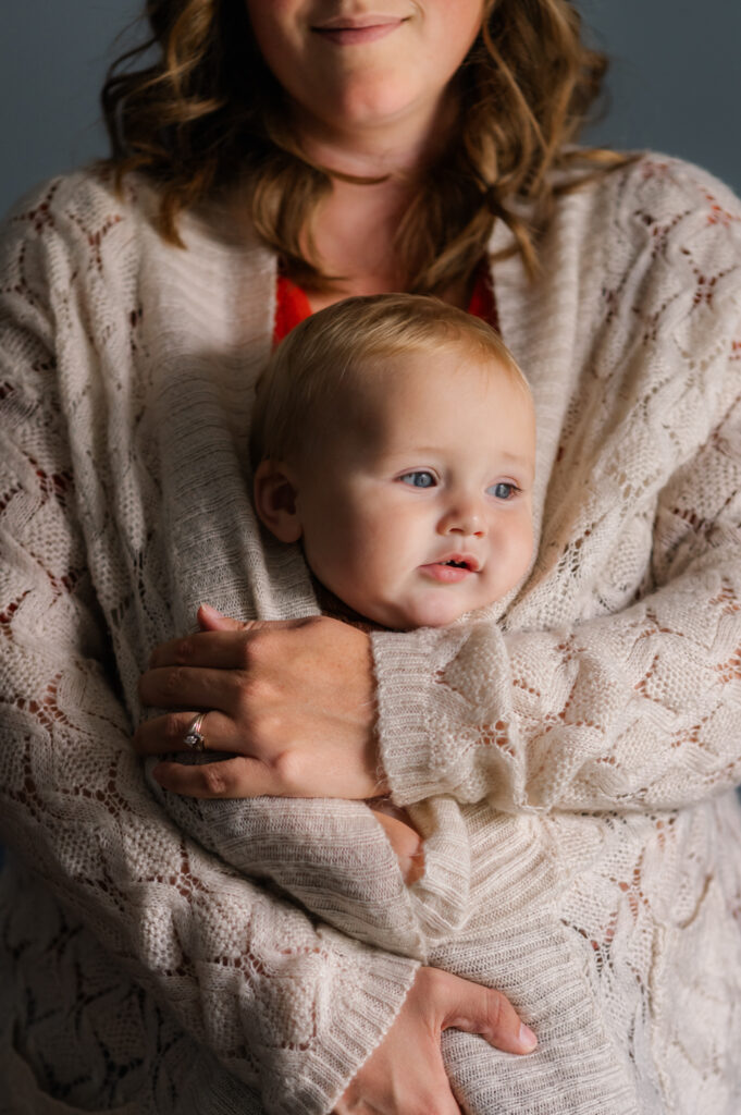 Developing Cozy Mom snuggling  baby in sweater