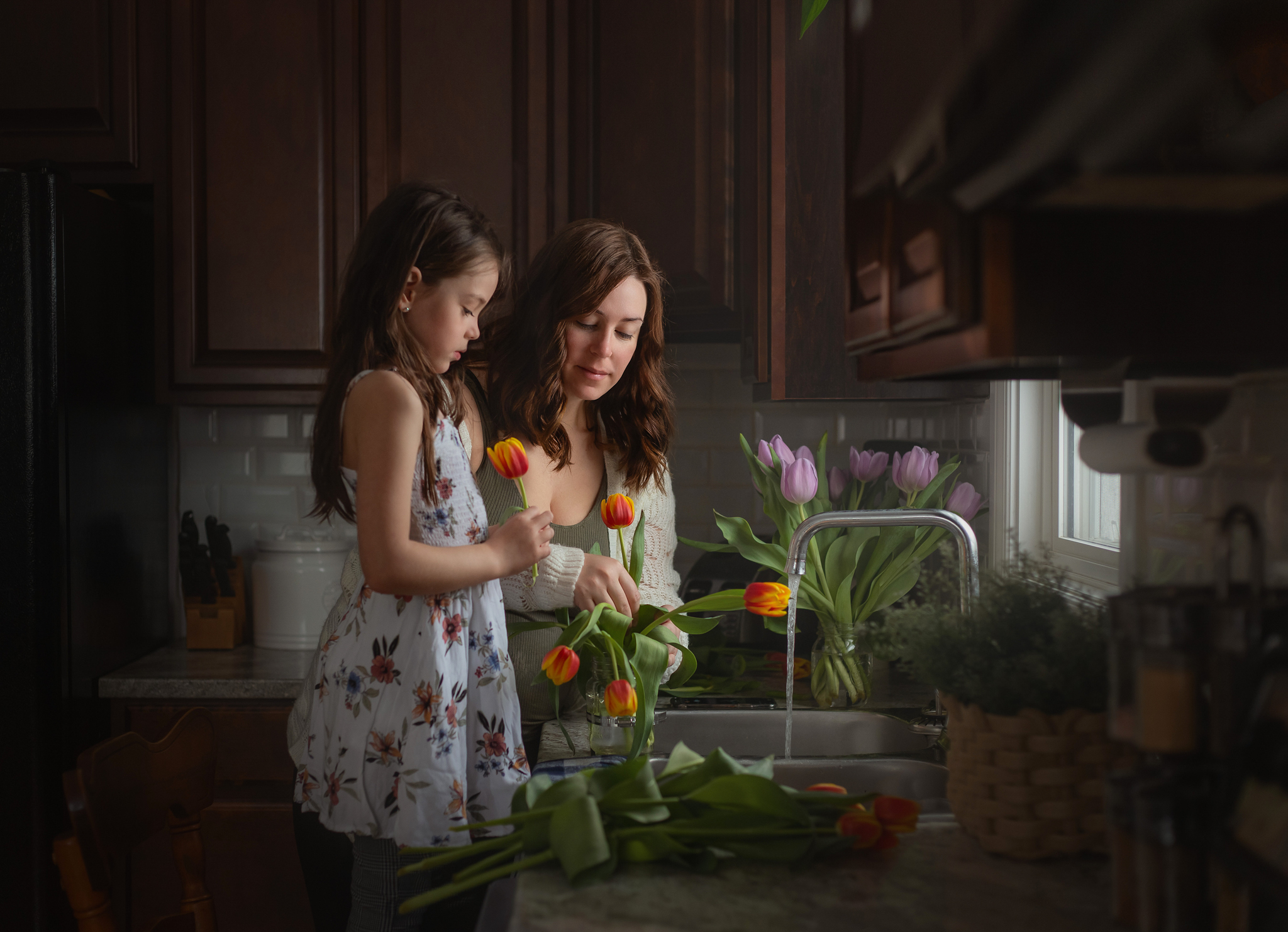 Mom and daughter putting flowers in vase