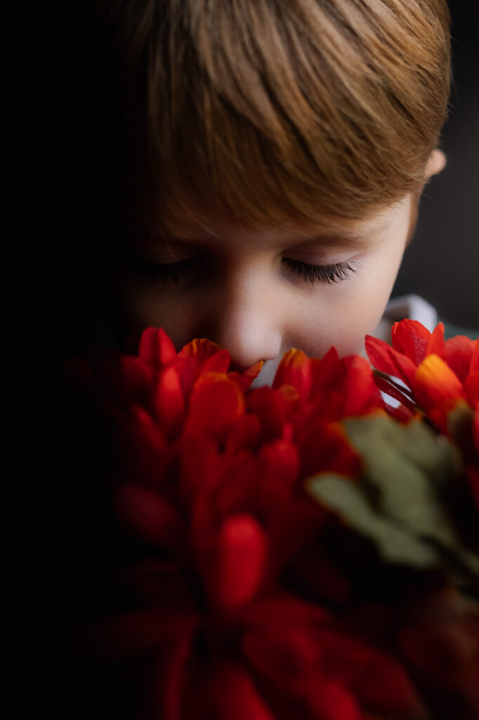 5 Spots in Your House to Capture Low Light Images - boy smelling flowers