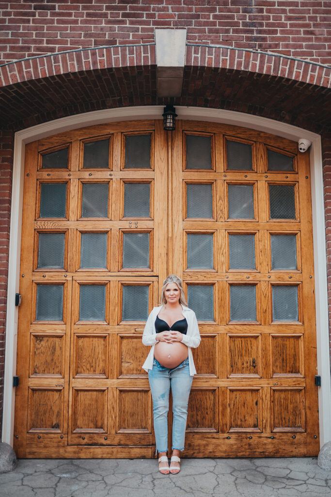 Bumping into Perfection - pregnant woman in front of wood door