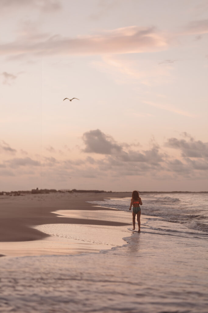 January Member Photo Challenge Winner - girl walking on the beach at sunset